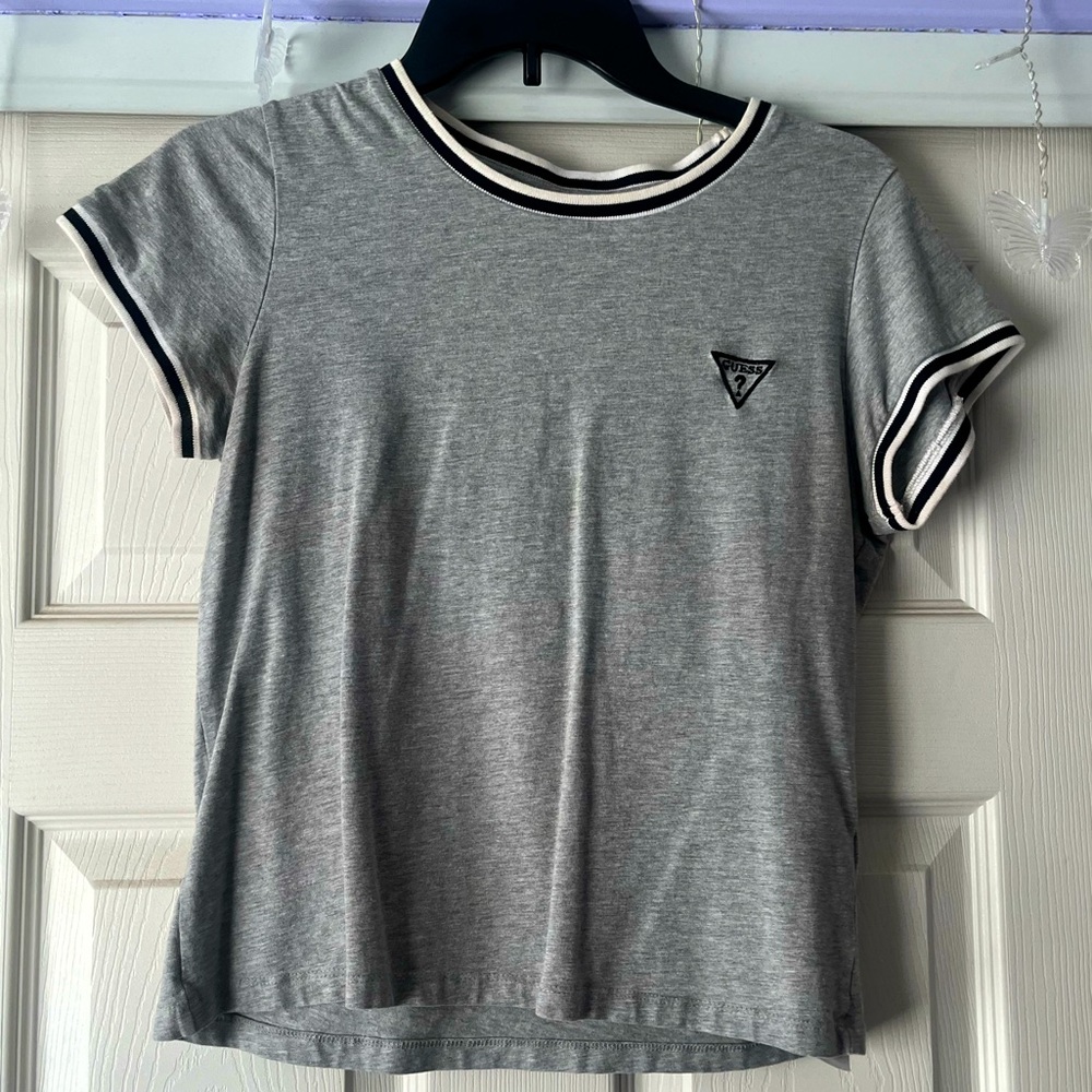 Grey tee and fits slightly cropped the arms are slight tight at the end.